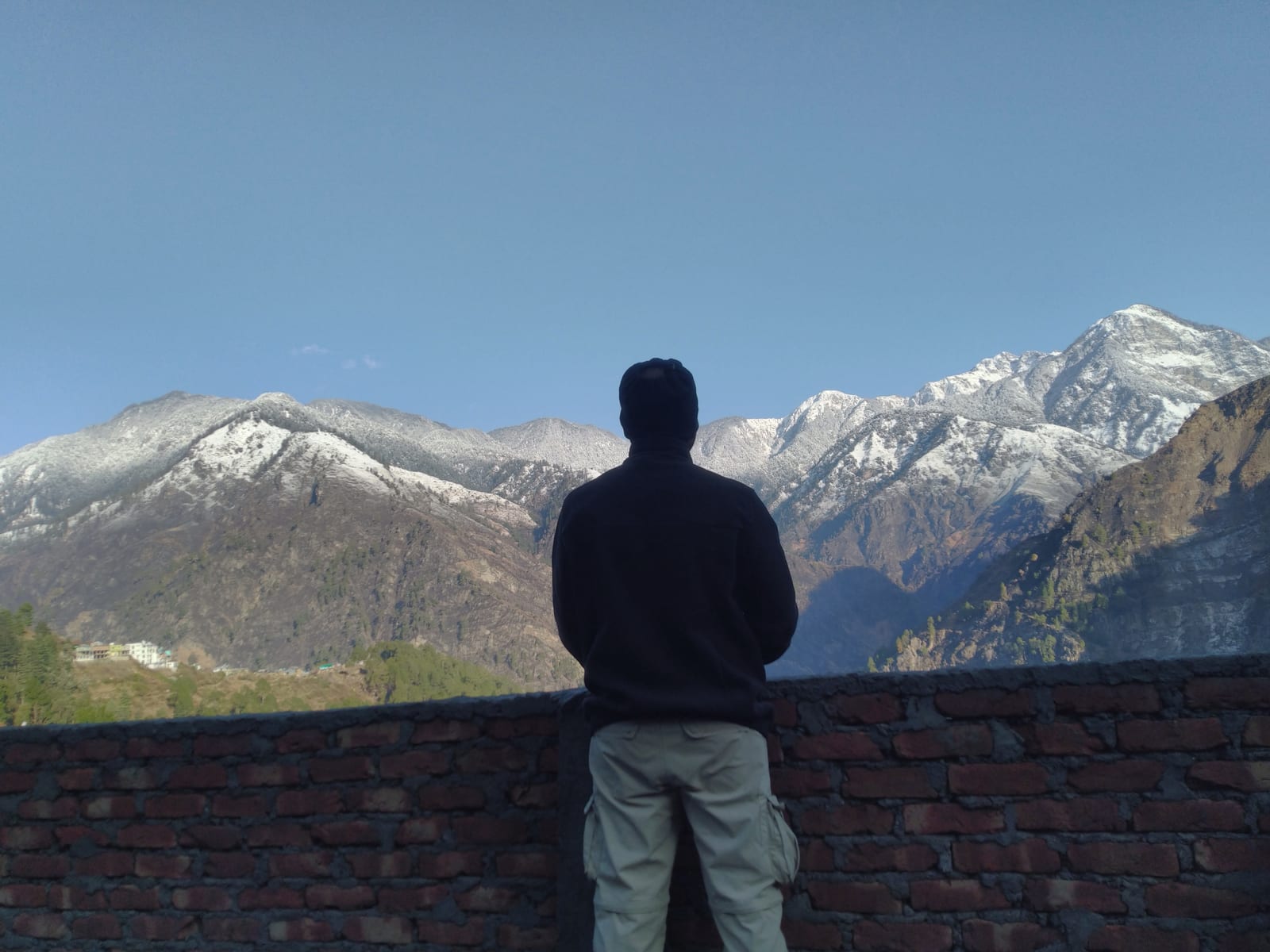 Priyank standing against snow-covered mountains